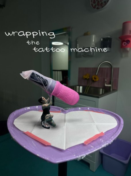 Mini Tia Berry figure wrapping the tattoo machine on her heart tattoo tray