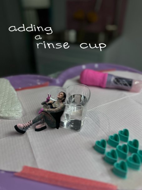 Mini Tia Berry figure adding a rinse cup on her heart tattoo tray