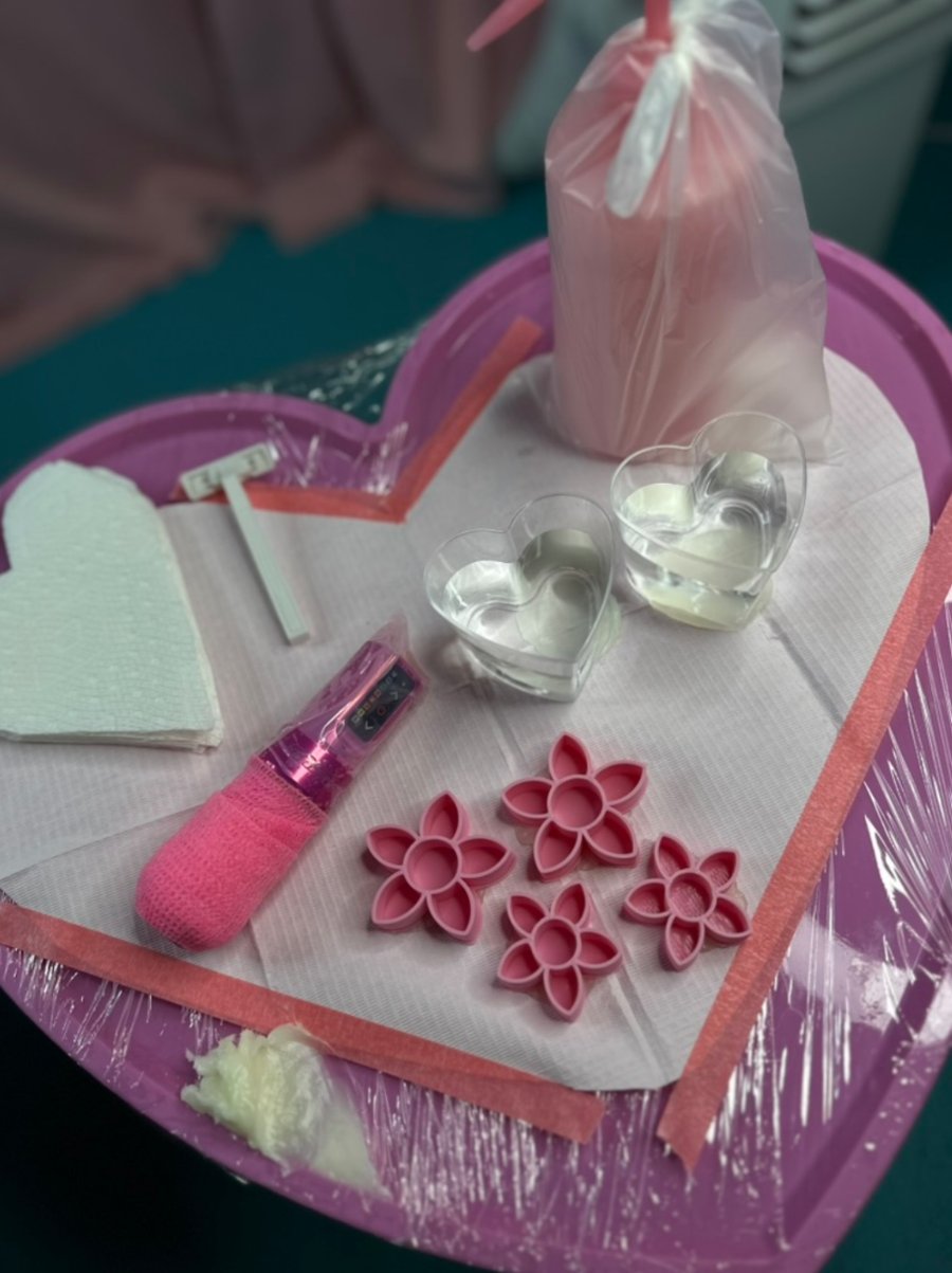 Tia Berry's favourite tattoo station setup: pink heart tray, pink wrapped machine, flower ink caps and heart rinse cups