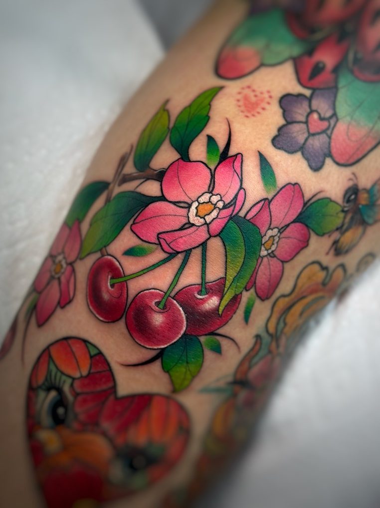 Cherries and blossoms tattoo on the knee by Tia Berry, colour tattoo artist in Vancouver