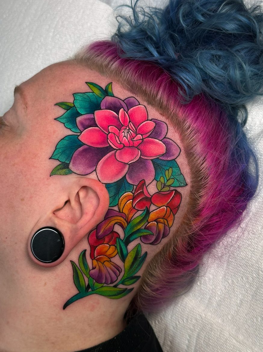Dahlia and snapdragons tattoo on the head by Tia Berry, colour tattoo artist in Vancouver