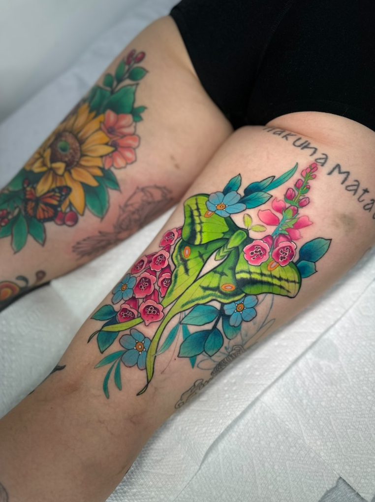 Luna moth and foxgloves tattoo on the thigh by Tia Berry, colour tattoo artist in Vancouver