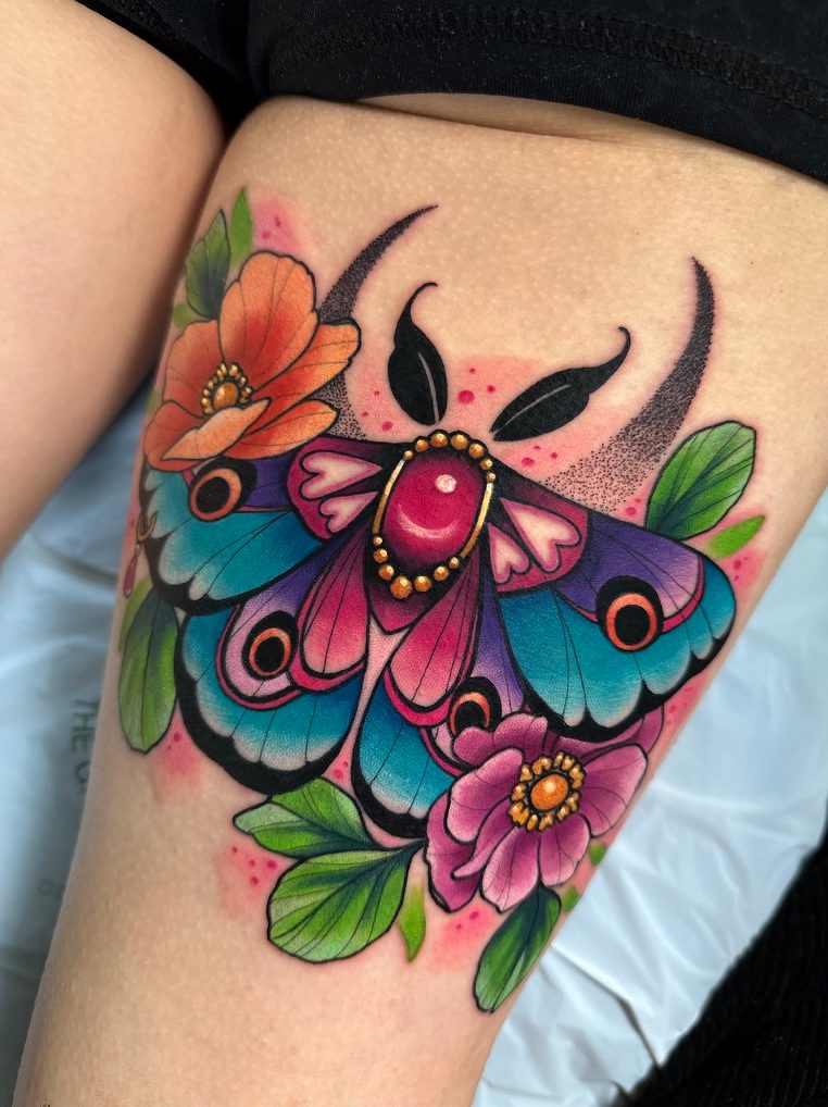 Moth and florals tattoo on the thigh by Tia Berry, colour tattoo artist in Vancouver
