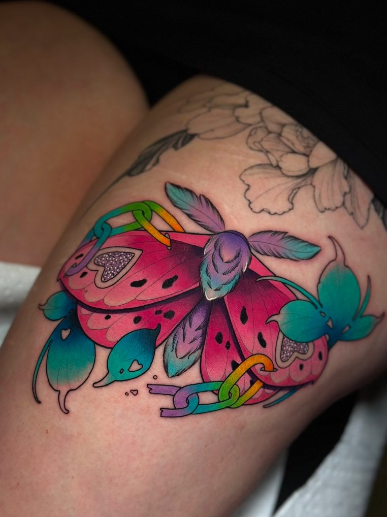 Moth and rainbow chains tattoo on the thigh by Tia Berry, colour tattoo artist in Vancouver